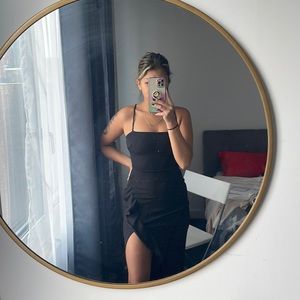 Black floor length gown with high leg slit.